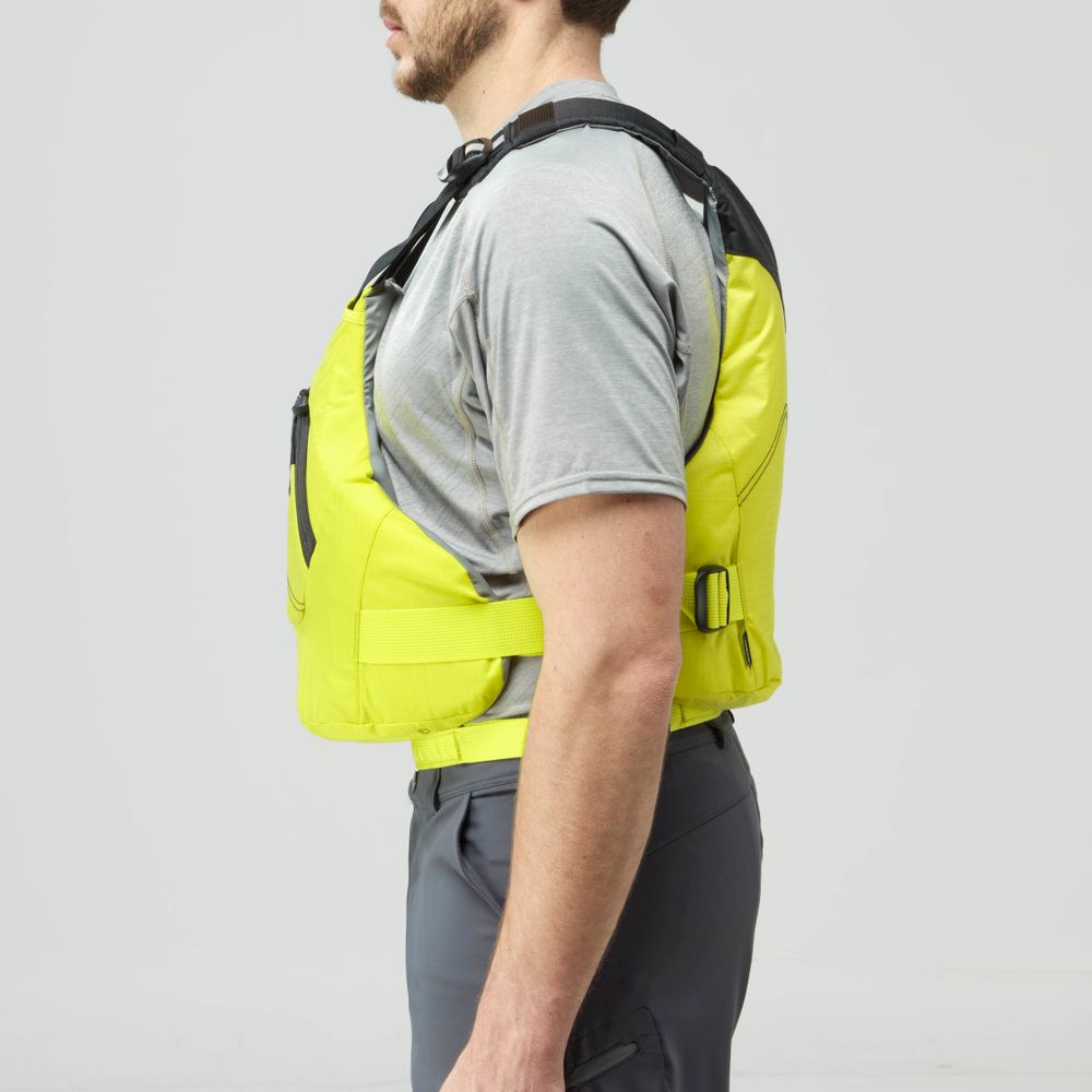 Side view of a man in a gray t-shirt, dark gray pants, and the bright yellow NRS Ion PFD life jacket, standing against a plain light background.