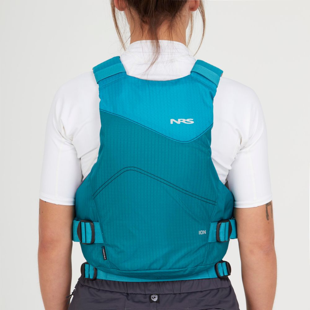 Someone is seen from behind wearing a teal NRS Ion PFD life jacket over a white shirt.
