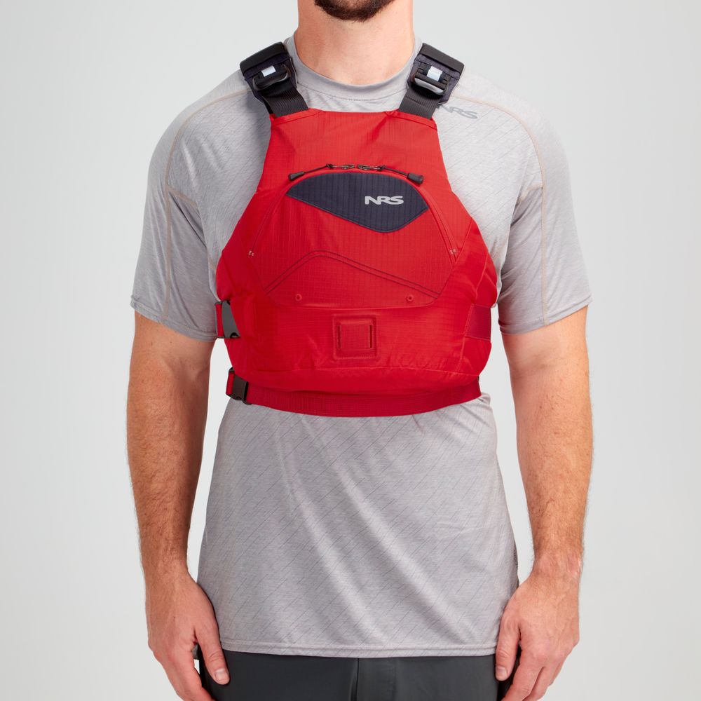 Someone wearing the red NRS Ion PFD, featuring ultra-soft foam, over a light gray shirt.