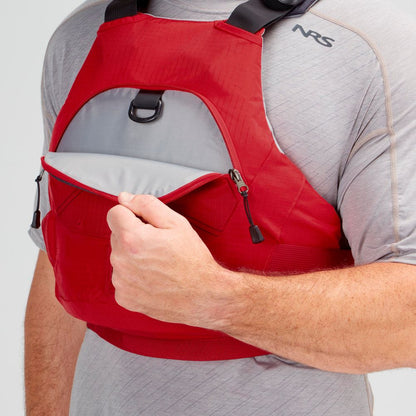 A person opens the front zippered pocket of a red NRS Ion PFD worn over a light gray shirt.