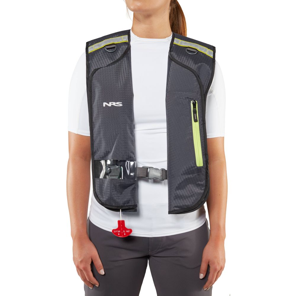 Someone wearing an NRS Matik Inflatable PFD, styled like a gray and black vest with a zip pocket, over a white short-sleeved shirt and gray pants.