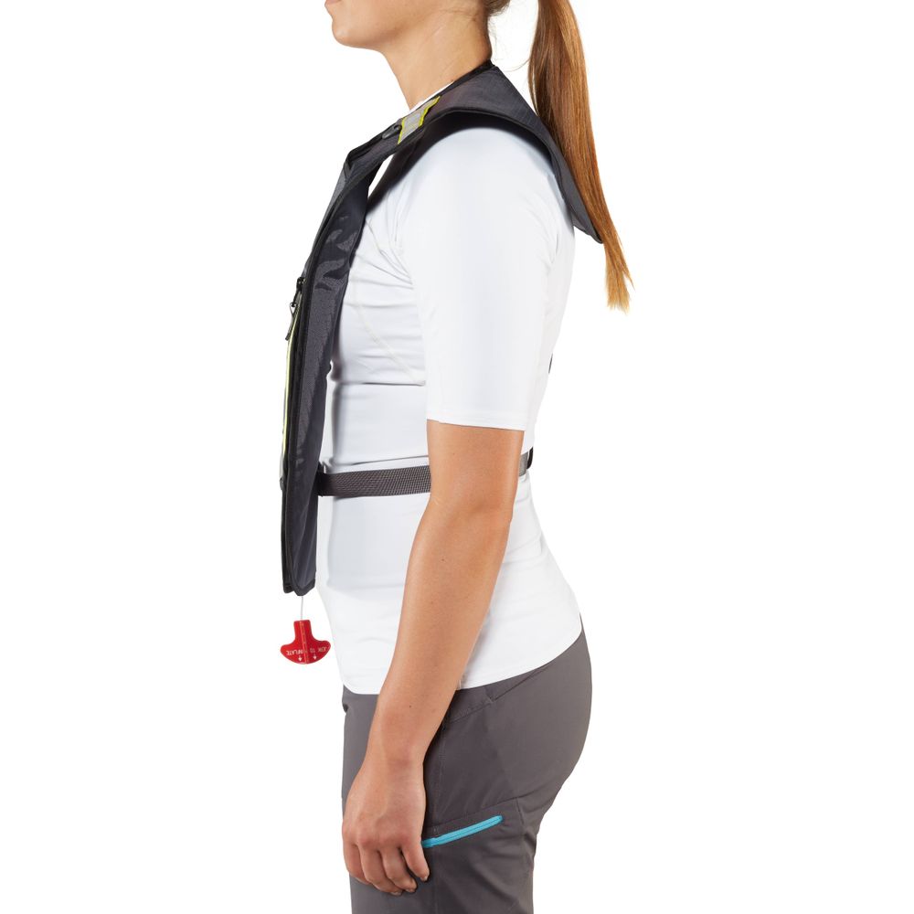 A person is seen from the side wearing an NRS Matik Inflatable PFD over a white shirt and gray pants.