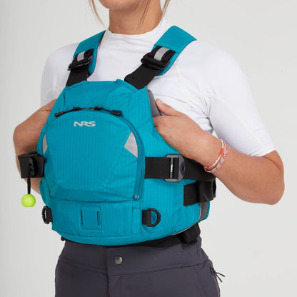 A person in a vivid blue NRS Ninja Pro PFD over a white shirt and gray pants adjusts the straps—showcasing this reliable rescue vest for whitewater paddlers.