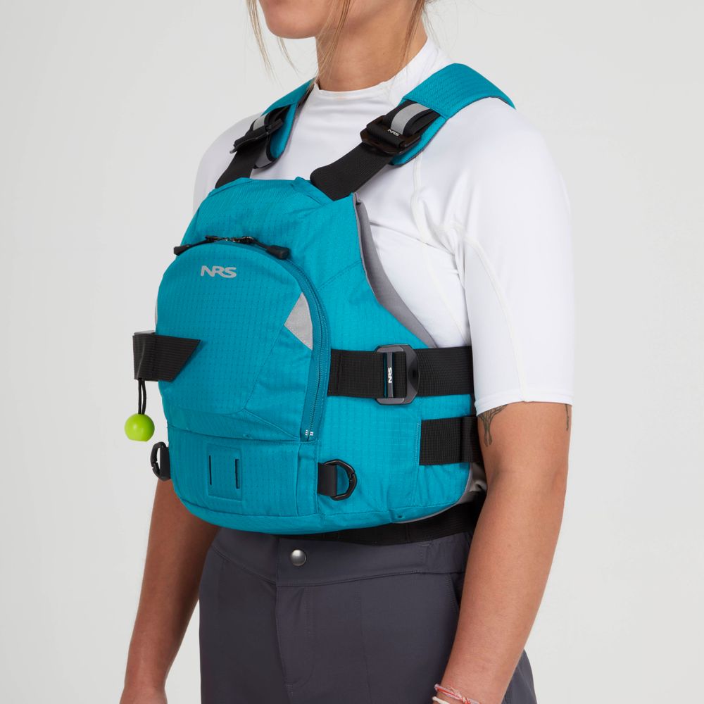 A person wears the NRS Ninja Pro PFD over a white shirt and gray pants, shown from the side to highlight the vest’s features and adjustable straps—designed for paddlers who value safety and comfort.