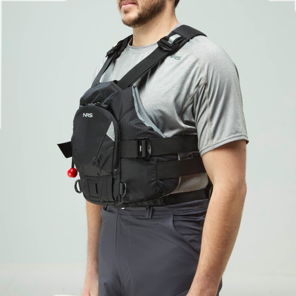 A man in a gray t-shirt models the NRS Ninja Pro PFD, a black rescue vest with straps and a front pocket—ideal for whitewater paddlers prioritizing safety and comfort.