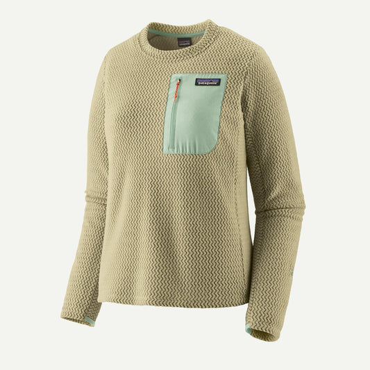 The Patagonia R1 Air Crew-W's is a beige textured, long-sleeve pullover made from recycled polyester with a mint green chest pocket and trim—a lightweight technical fleece ideal for any adventure.