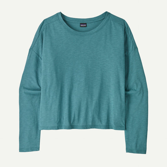The Mainstay Top by Patagonia, a teal long-sleeve shirt with a round neckline, is laid flat against a light background.