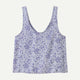 The Patagonia Garden Island Top is a sleeveless light blue crop top with a scooped neckline and dark blue floral pattern.