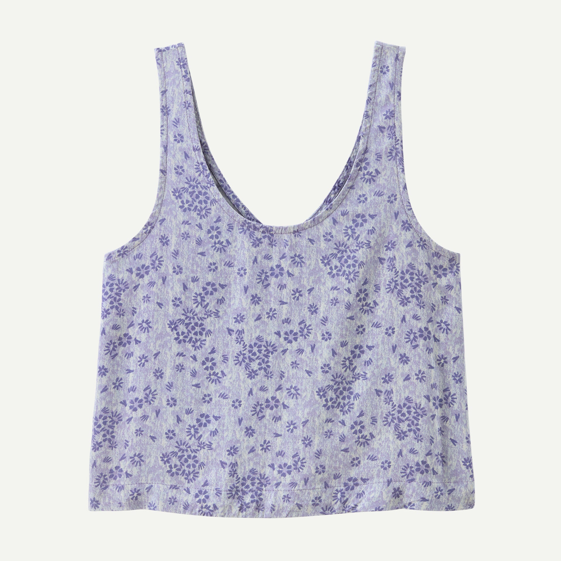 The Patagonia Garden Island Top is a sleeveless light blue crop top with a scooped neckline and dark blue floral pattern.