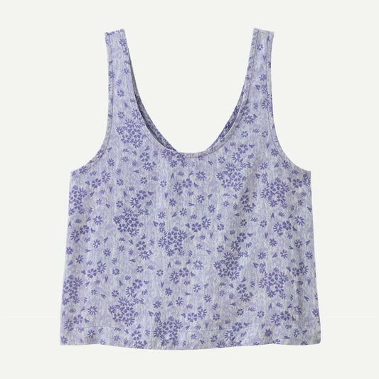 The Patagonia Garden Island Top is a sleeveless light blue crop top with a scooped neckline and dark blue floral pattern.