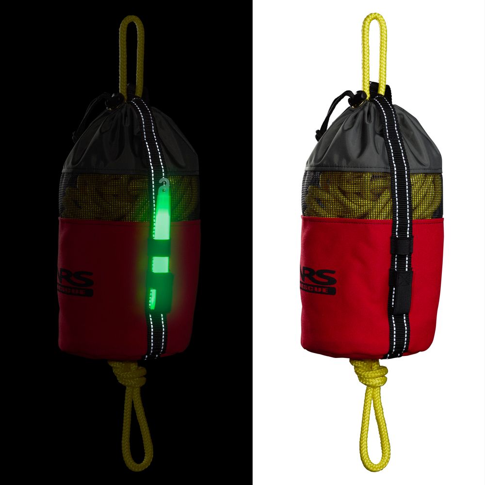 The NRS Standard Rescue Throw Bag 75' is made of red and gray Cordura Nylon and contains a vibrant yellow polypropylene rope. It features a strap that glows green in the dark on one side, with normal coloring visible on the other.