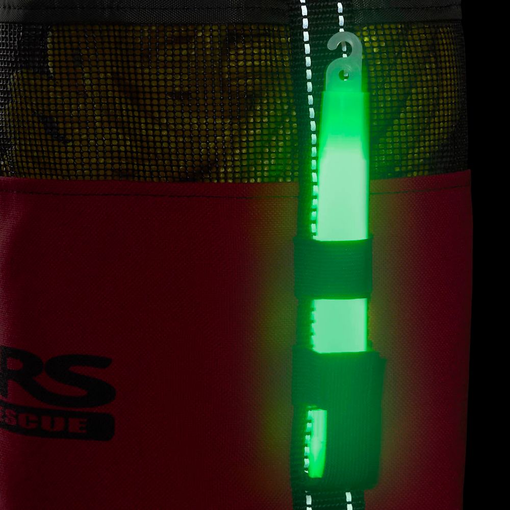 A glowing green light stick is attached to a Standard Rescue Throw Bag 75' by NRS, featuring black and red Cordura Nylon with partially visible letters "RS.