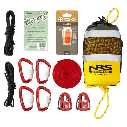 Flat lay of the NRS Kayak Un-Pin Kit, including ropes, four red carabiners, two pulleys, a throw bag, whistle, and a Z-Drag rescue system instruction card for whitewater safety.