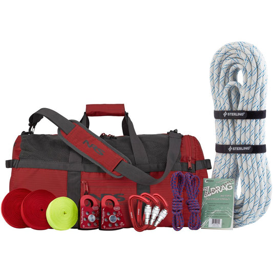 The NRS Z-Drag Kit is a red duffel bag packed with rope, rescue throw bags, carabiners, pulleys, a whistle, and an instruction manual—ideal for whitewater boat extractions or as part of a mechanical advantage rescue system.