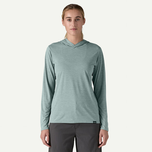 A person wears the Patagonia Cap Cool Daily Hoody - Womens in light blue, made from recycled polyester, with dark pants, standing facing forward against a plain background.