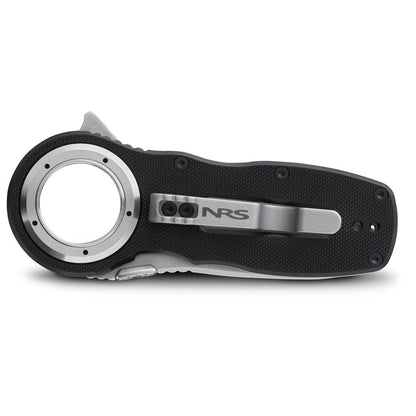 The NRS Pilot Access Knife is a black and silver folding knife featuring a stainless steel, serrated blade with a circular opening near the handle and a side clip.