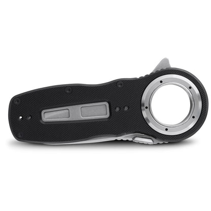 A black Pilot Access Knife by NRS, featuring a closed folding design with a stainless steel blade and an all-weather G10 textured handle, is lying flat.