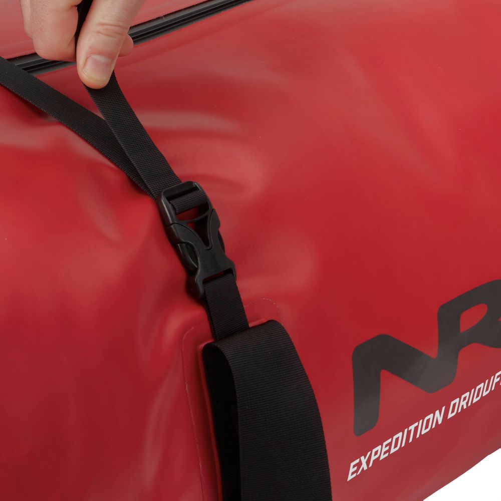 Securing the black strap on a red NRS Expedition DriDuffel equipped with a TRU Zip zipper for maximum protection.