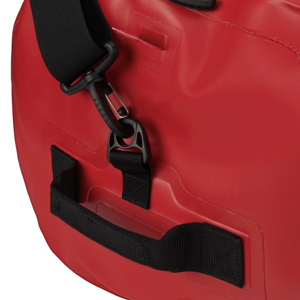 Close-up of a red NRS Expedition DriDuffel with black straps and metal clasps, showcasing its waterproof design and TRU Zip zipper.