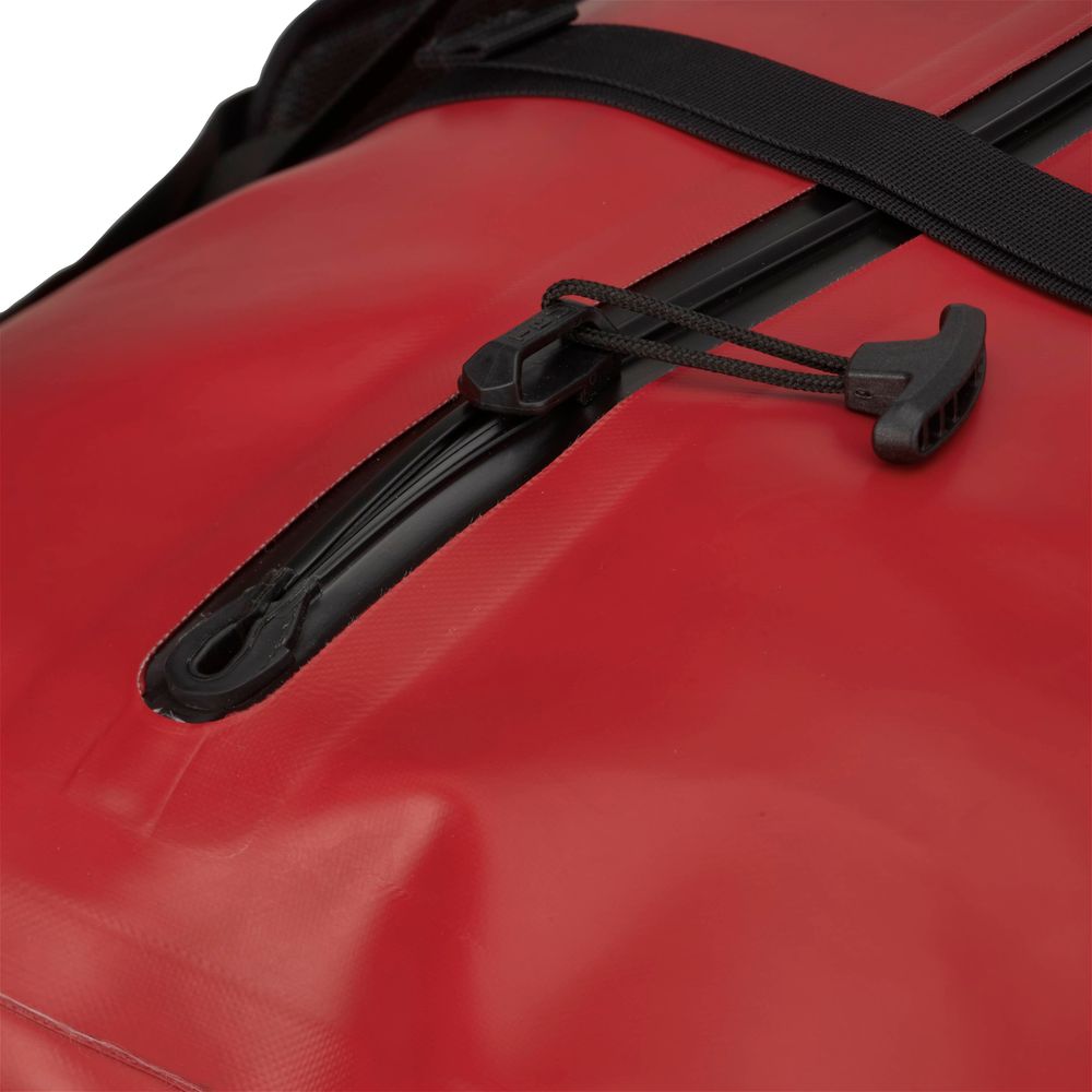 Close-up of the NRS Expedition DriDuffel, a red waterproof duffel bag with a sleek black TRU Zip zipper and an adjustable strap.