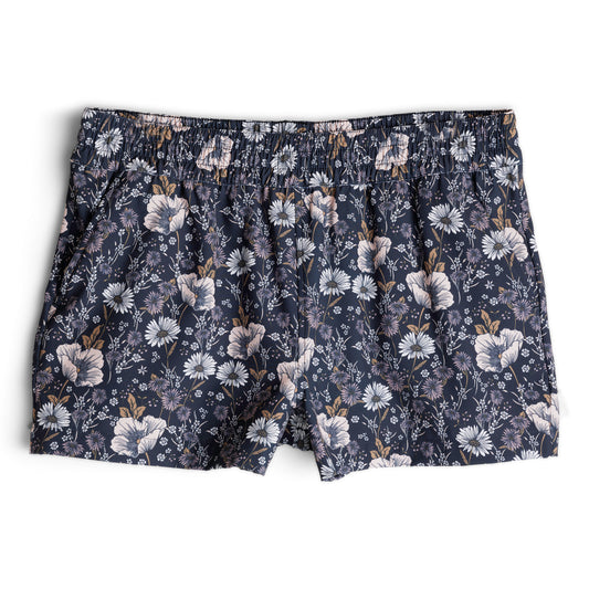 The Kavu Kick Out Shorts for women by Kavu feature an elastic waistband, an all-over white and beige floral print, and a hidden security pocket for added convenience.