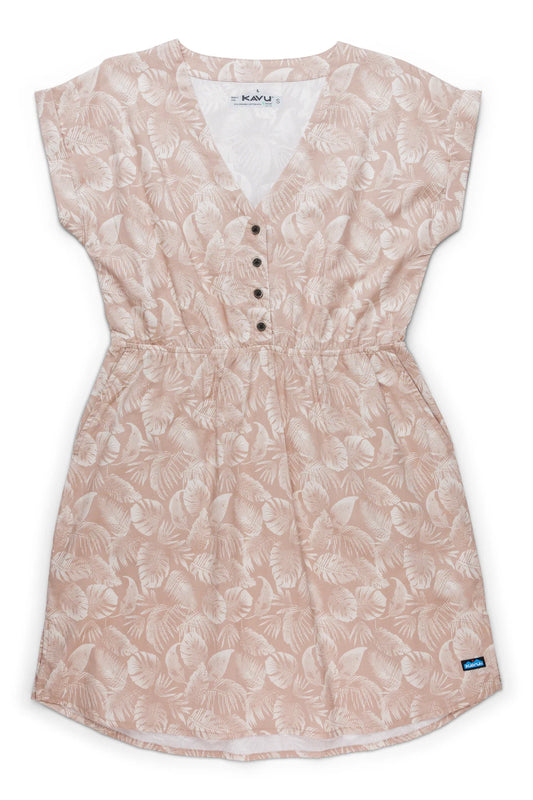 The Kavu Dreamview Dress is a short-sleeve, knee-length A-line with a light pink and white leaf pattern, v-neck with buttons, elastic waist, and a small blue tag near the hem.