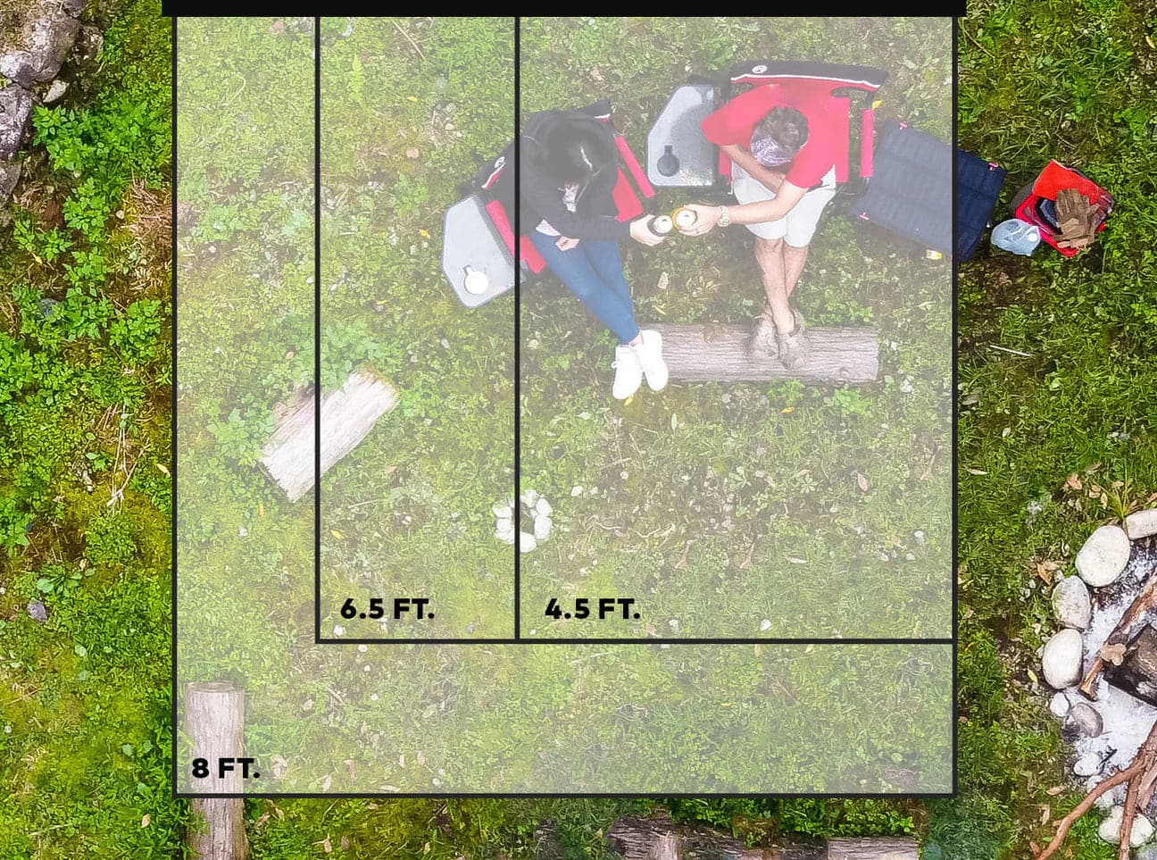 An aerial view of a group of people camping in the woods with the Slim Shady 6.5 by Yakima.