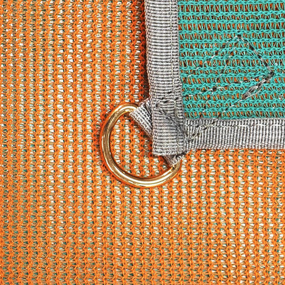 A close-up of the NRS Sand Free Multi Mat shows its orange and green dual weave design with a gray border, featuring a gold metal ring at the intersection, highlighting detailed craftsmanship similar to a camping tarp.