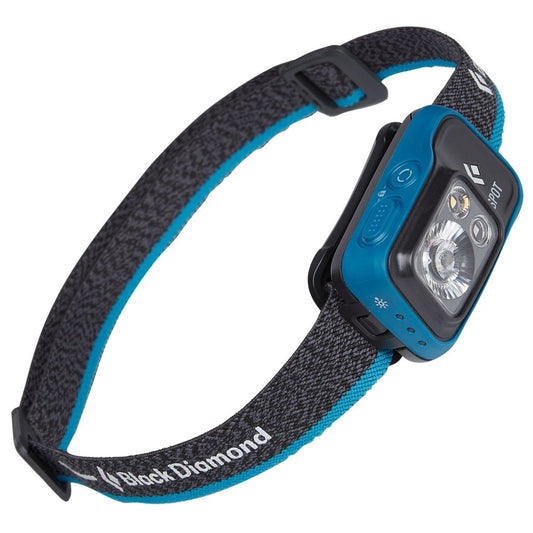 The Black Diamond Spot 400 Headlamp has a 400-lumen LED, blue front buttons, dual-battery system, and an adjustable black and blue strap.