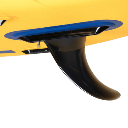Close-up of an 8in Flex Fin by SOL Paddle Boards attached to the bottom of a yellow surfboard, ideal for deep river running.