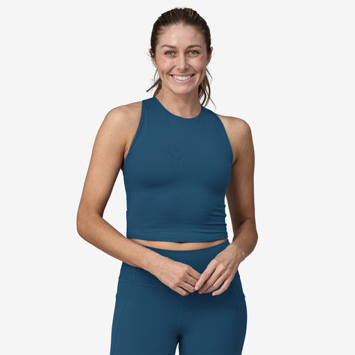 A woman wearing a Patagonia Reversible Tank and leggings.