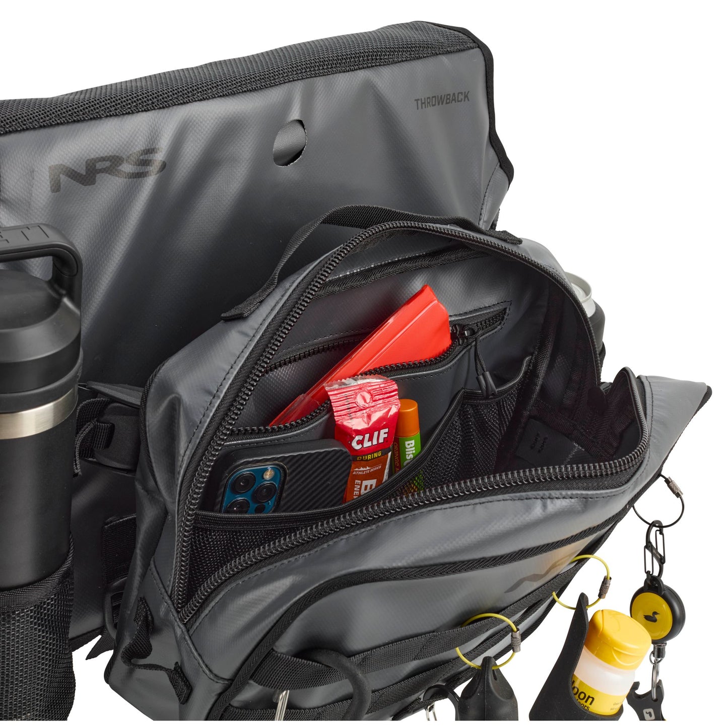 The NRS Throw Back Fishing Seat Bag in gray is shown with its main pocket open, holding a phone, Clif Bar, red wallet, and more—ideal as a quick-drying mesh fishing seat bag or compact storage for small essentials.