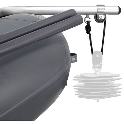 The Slipstream Fishing Raft by NRS features gray fenders, a metal rod, and a pulley system with stacked plastic plates for enhanced durability in whitewater. It's ideal for those seeking reliable shallow water performance.