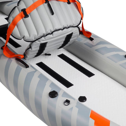 Close-up of the NRS Akamai 110 Inflatable Kayak shows a grey and white seat with orange straps and two long black strips on its PVC-free nylon floor.