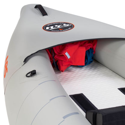A close-up of the NRS Akamai 110 Inflatable Kayak reveals its gray PVC-free nylon build and a zippered bow compartment safely storing red and blue clothing.