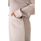A person wears the Lole Yonder Hoodie Dress in beige, with their right hand inside the side pocket; only the torso and arm are visible.