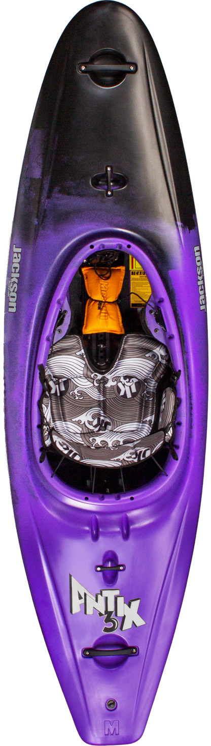 A top-down view of the Jackson Kayak Antix 3.0 whitewater kayak in purple and black, featuring a patterned seat and visible footrests inside.