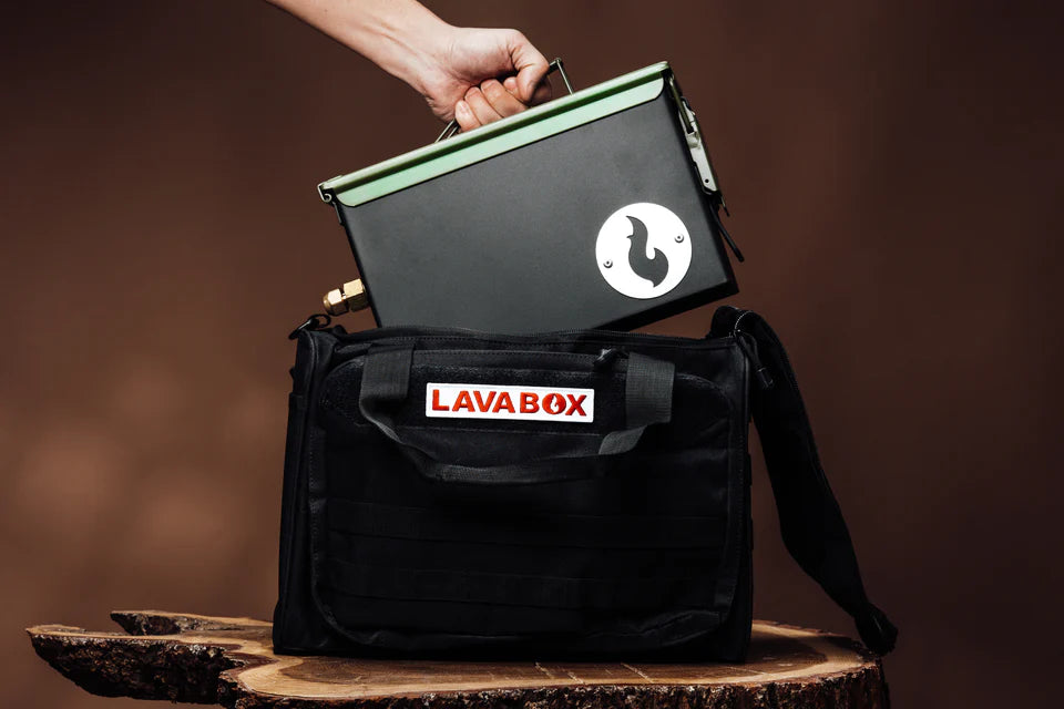 A person is holding a BugOut Bag for LavaBox, containing a 304 Stainless Steel hot pad for grilling.