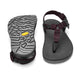 The Bedrock Carin 3D Pro II is a pair of black hiking sandals with adjustable straps and a secure fit; one sandal is shown from above, while the other displays its Vibram Megagrip outsole’s textured tread.