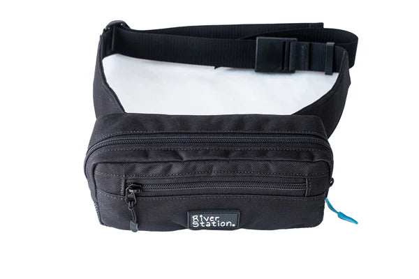 The Zip Hip Pack Waist Throw Bag by River Station Gear is a black waist bag with two zippered compartments and an adjustable quick-release strap, ideal for carrying essentials in a compact, easy-access design.