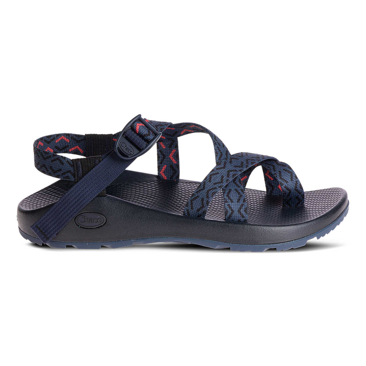 The Chaco Z2 Classic - Men's sandal features navy blue adjustable patterned straps, a supportive footbed, and a durable sole—shown in side profile to highlight its classic outdoor style.
