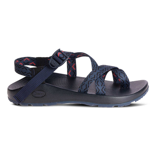 The Chaco Z2 Classic - Men's sandal features navy blue adjustable patterned straps, a supportive footbed, and a durable sole—shown in side profile to highlight its classic outdoor style.