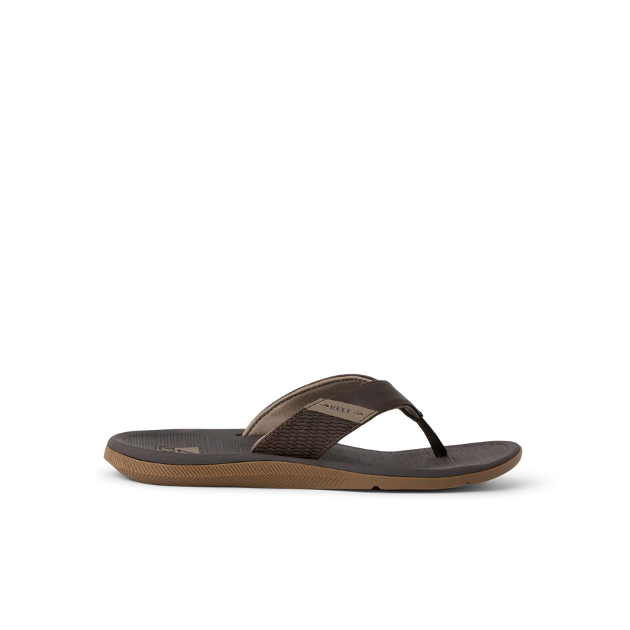 The REEF SANTA ANA sandal in brown features a textured footbed and sole for water-friendly comfort and style, shown against a plain white background.