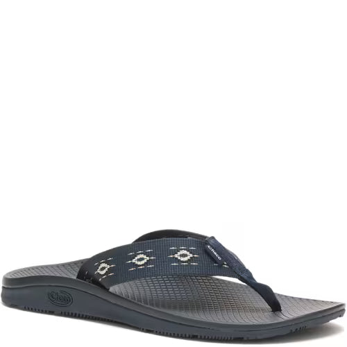 The Chaco CLASSIC FLIP - WOMEN'S is a dark blue, vegan-friendly sandal featuring a patterned fabric strap, textured footbed, and arch support comfort, displayed on a white background.