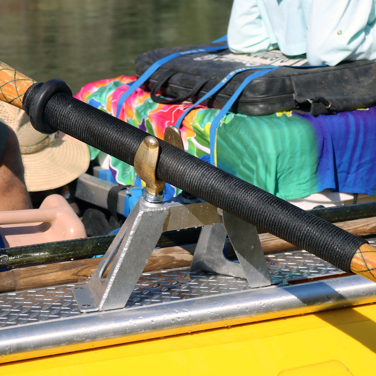 A yellow Sawyer boat on the water with Canyon Oarlock - Threaded.