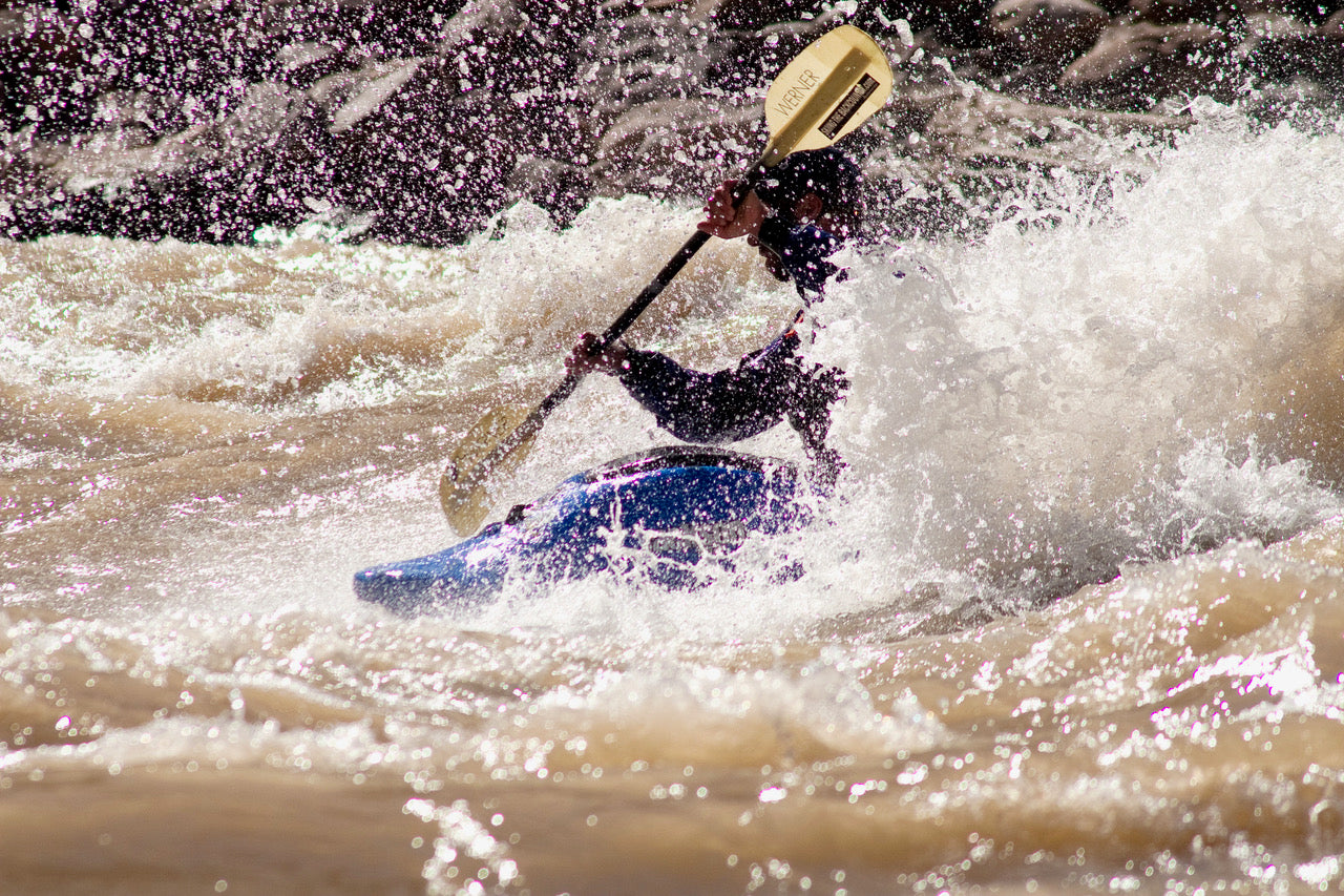 Braving Class III rapids in Cataract Canyon, this kayaker experiences the excitement of 4CRS Paddle School’s Intro to Big Water Kayaking.
