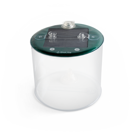 The BioLite Luci Charge 150 is a transparent cylindrical container with a dark green lid, two clear nozzles, and the BioLite logo on top—designed for portable lighting and mobile charging anywhere.