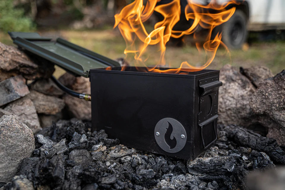 A VolCanNo Tacana Combo camp stove with a flame sitting on top of it, perfect for use during campfire bans from the brand LavaBox.