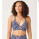 A woman wearing a Carve Dahlia Top bikini top.