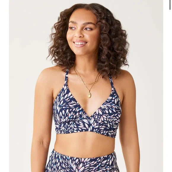 A woman wearing a Carve Dahlia Top bikini top.